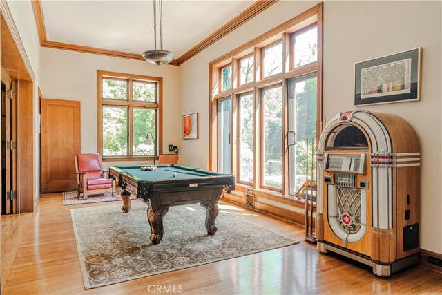 recreation room with light hardwood / wood-style flooring, ornamental molding, and pool table