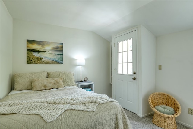 carpeted bedroom featuring lofted ceiling