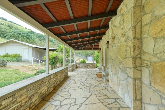 view of patio / terrace featuring a storage shed