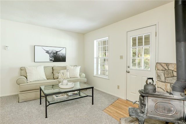 carpeted living room featuring a wood stove