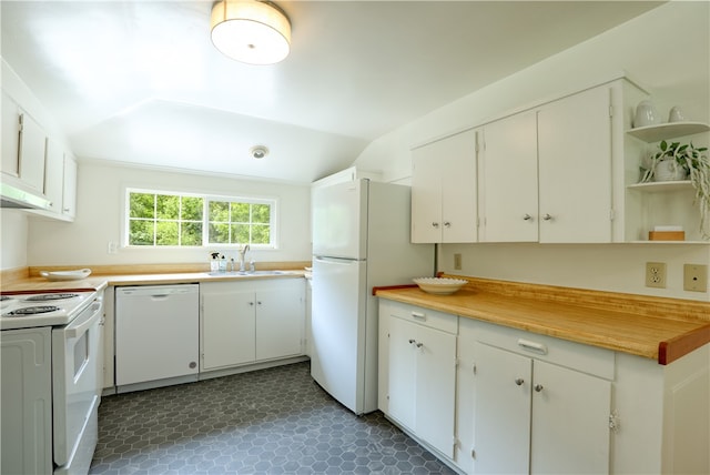 kitchen with white appliances, white cabinets, sink, and dark tile floors