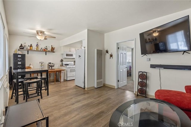 living room featuring ceiling fan and wood-type flooring