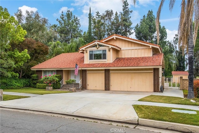 view of front of home with a garage and a front lawn