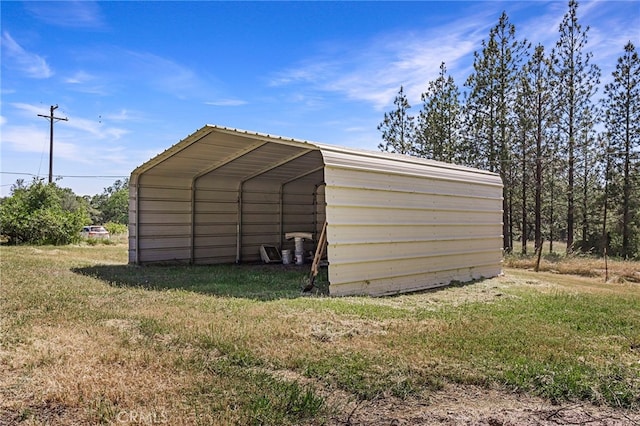 view of outbuilding featuring a lawn and a carport