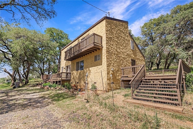 view of property exterior with a wooden deck