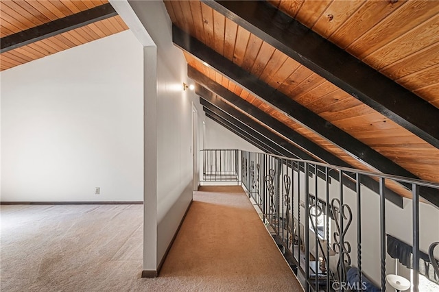 additional living space with vaulted ceiling with beams, wood ceiling, and carpet floors