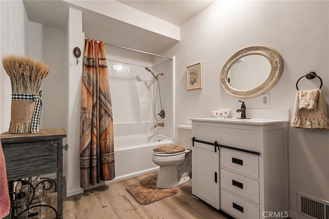 full bathroom with shower / tub combo with curtain, wood-type flooring, toilet, and vanity