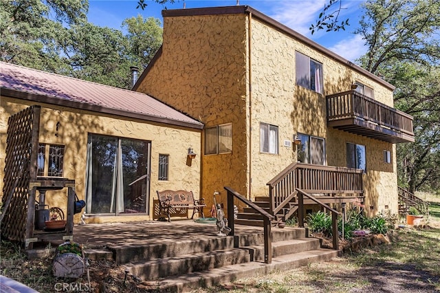 back of property with a balcony