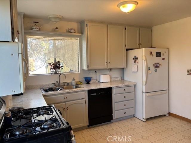 kitchen featuring white fridge, black dishwasher, sink, and white cabinets
