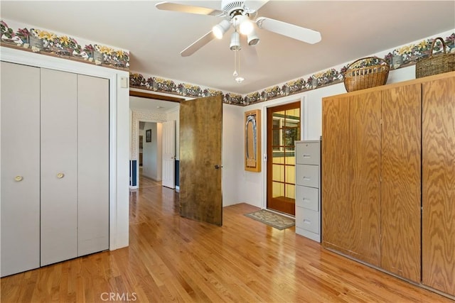 unfurnished bedroom featuring ceiling fan, a closet, and light hardwood / wood-style floors