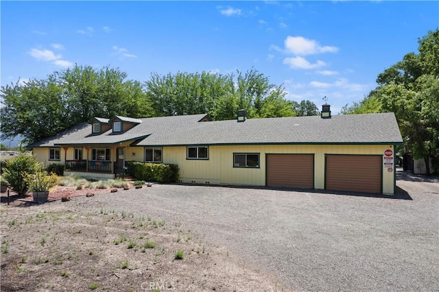 ranch-style home featuring a garage and covered porch