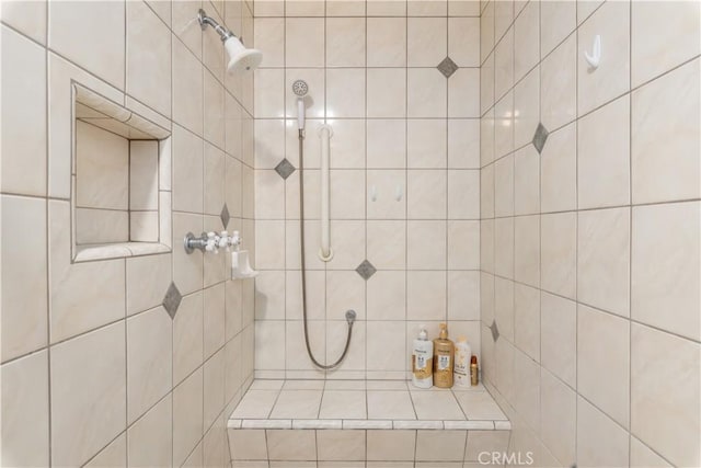 bathroom with tiled shower