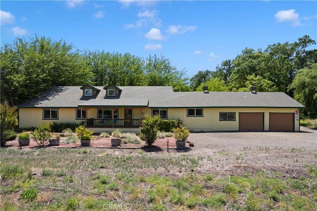 view of front of house featuring a porch and a garage