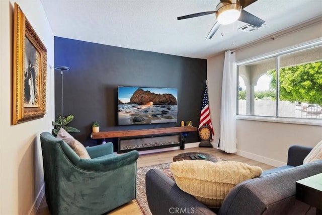 cinema featuring hardwood / wood-style floors and ceiling fan