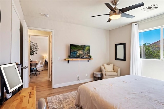 bedroom with ceiling fan and light wood-type flooring