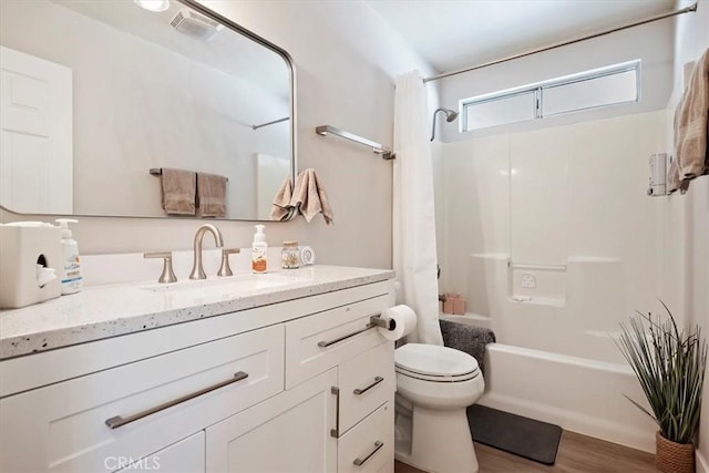 full bathroom featuring hardwood / wood-style flooring, vanity, toilet, and shower / bath combination