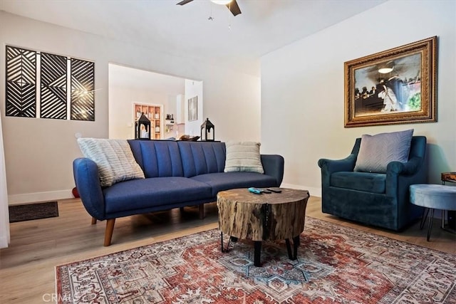 living room featuring ceiling fan and hardwood / wood-style floors