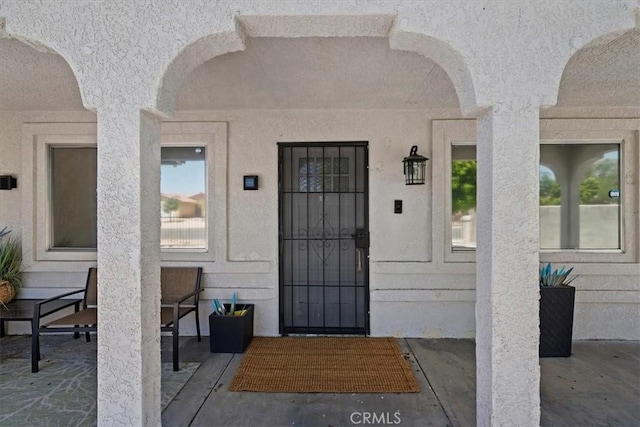 view of exterior entry featuring a patio area