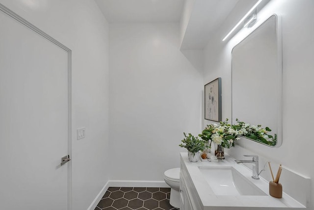 bathroom with toilet and vanity