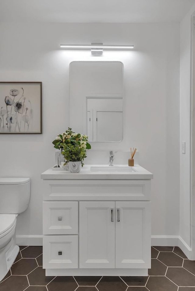 bathroom featuring toilet and vanity