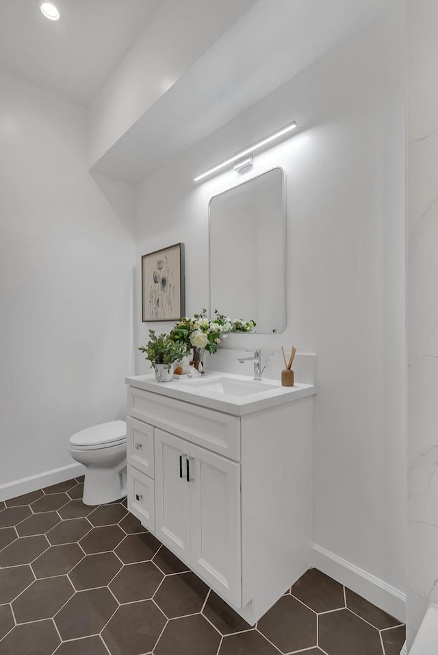 bathroom with tile patterned floors, toilet, and vanity