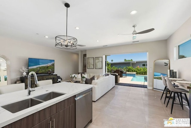 kitchen featuring dishwasher, a wealth of natural light, hanging light fixtures, and sink