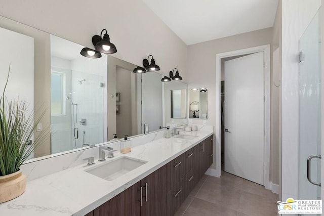 bathroom with tile patterned floors, vanity, and walk in shower