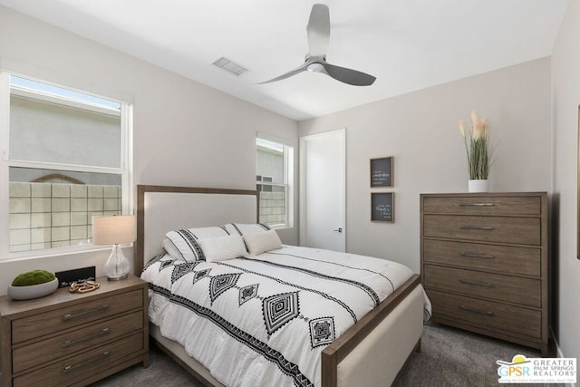 bedroom featuring ceiling fan and dark carpet