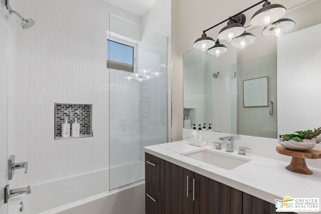 bathroom featuring vanity, tiled shower / bath combo, and a chandelier