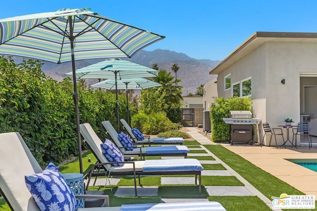 view of patio / terrace featuring a mountain view and grilling area