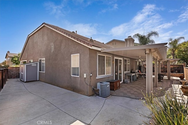 back of house featuring central AC unit, a patio area, and ceiling fan