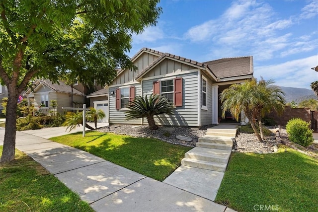 view of front of home with a garage and a front yard