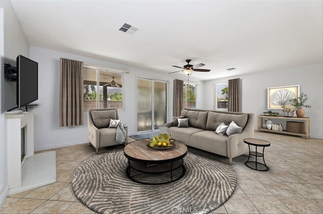 living room with ceiling fan and light tile patterned flooring