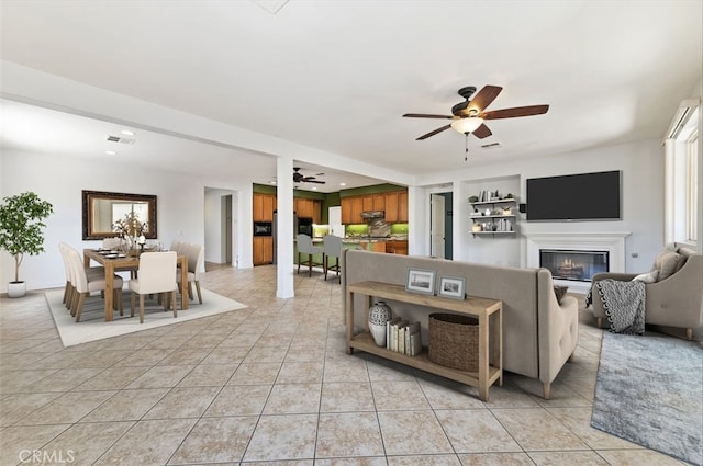 living room with light tile patterned flooring and ceiling fan