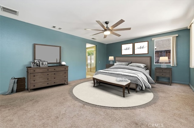 carpeted bedroom featuring ceiling fan and ensuite bath