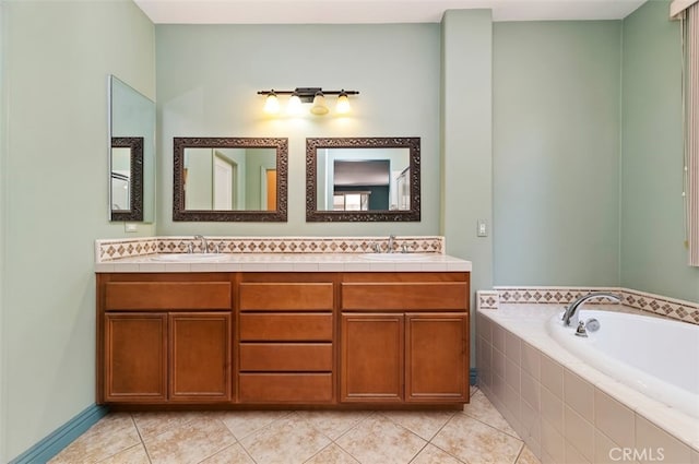 bathroom with tiled tub, vanity, and tile patterned floors