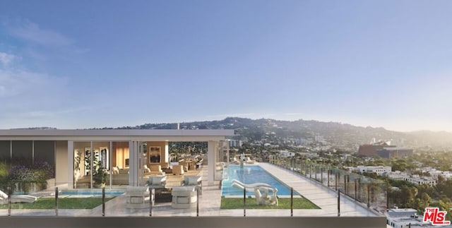 view of swimming pool with an outdoor living space, a patio area, and a water slide