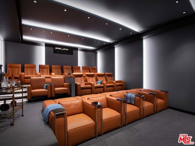 carpeted home theater featuring crown molding