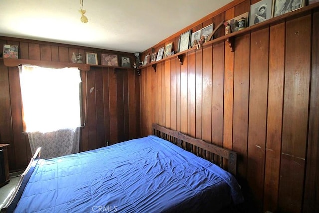 bedroom with wood walls