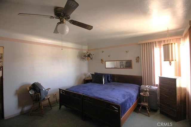 carpeted bedroom featuring ornamental molding and ceiling fan