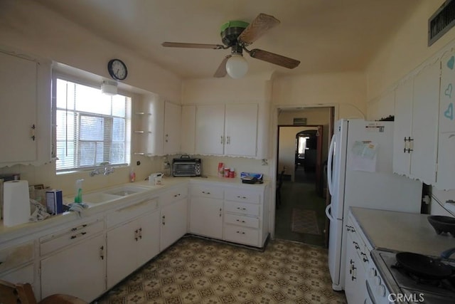 kitchen featuring ceiling fan, sink, white cabinets, and white appliances