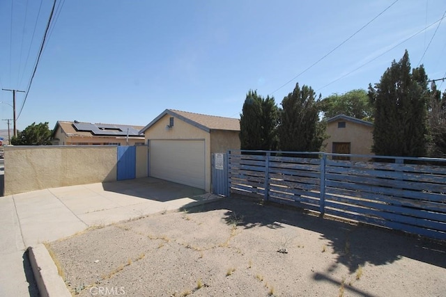 view of front facade with a garage and an outdoor structure