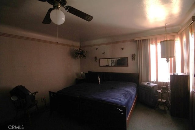 carpeted bedroom with crown molding and ceiling fan