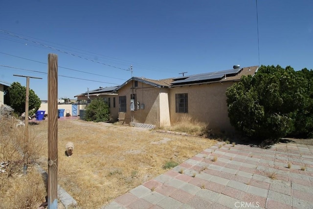 view of side of home with solar panels