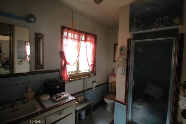 bathroom with sink, ceiling fan, tasteful backsplash, vaulted ceiling, and tile patterned floors