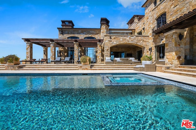 view of swimming pool with a patio area, an outdoor hangout area, and an in ground hot tub