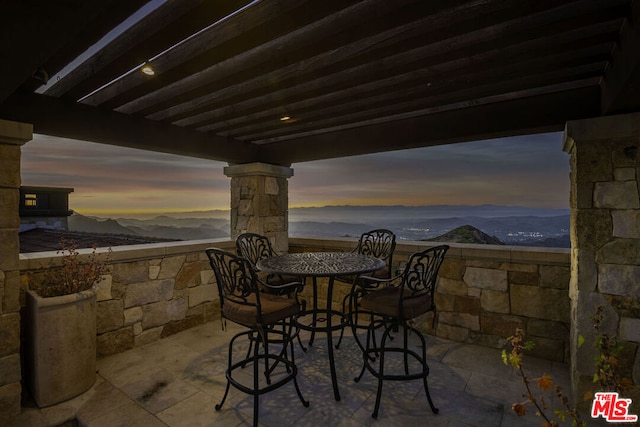 patio terrace at dusk with a mountain view