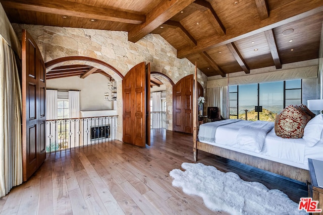 unfurnished bedroom with beamed ceiling, wood ceiling, and hardwood / wood-style floors