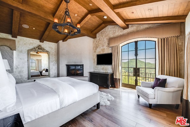 bedroom featuring a notable chandelier, access to outside, a multi sided fireplace, hardwood / wood-style flooring, and wooden ceiling