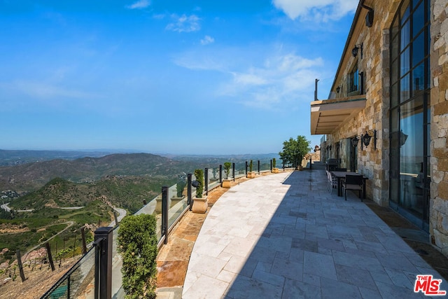 view of terrace with a mountain view